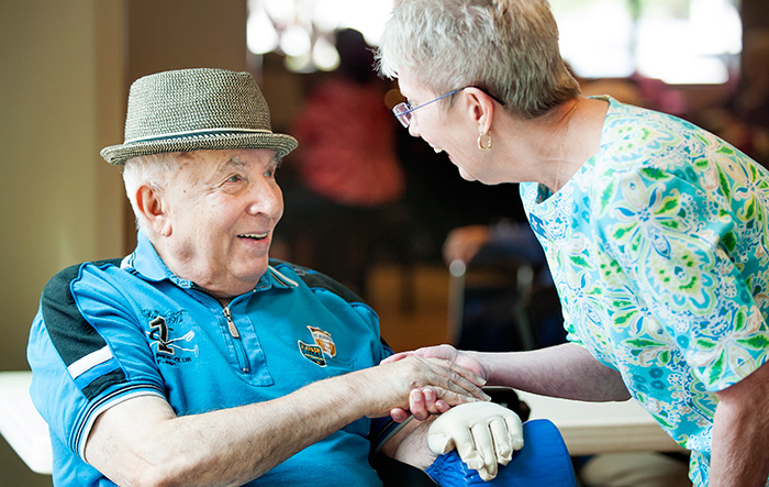 a volunteer greets a resident